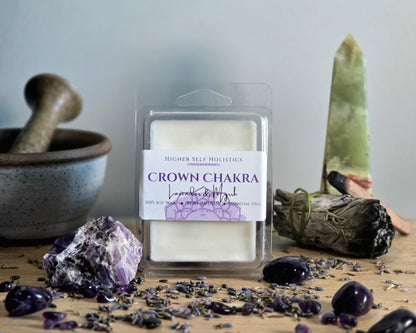 Crown Chakra Wax Melt in a clear container on a wooden surface with crystals, dried herbs,  smudge bundles, and a small mortar & pestle.